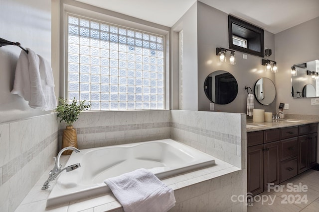 bathroom featuring vanity and a relaxing tiled tub