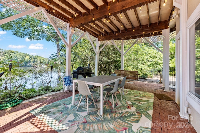 view of patio / terrace with area for grilling and a water view