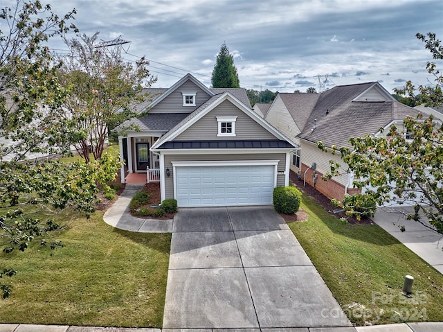 view of front of house featuring a garage and a front lawn