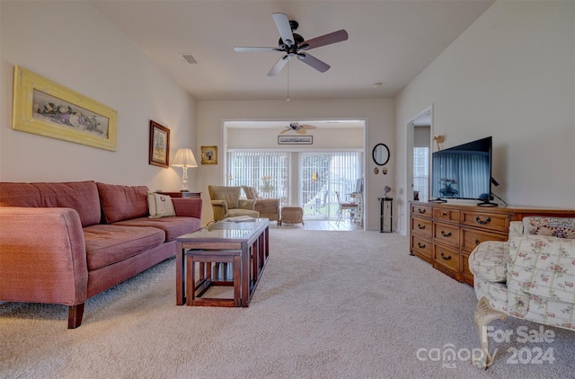 carpeted living room with ceiling fan