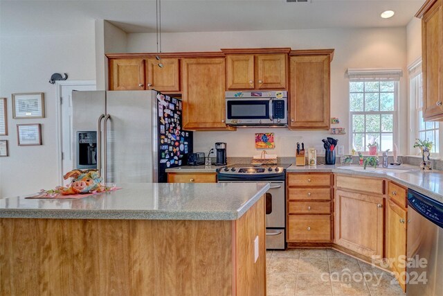 kitchen featuring sink, light tile patterned floors, and appliances with stainless steel finishes