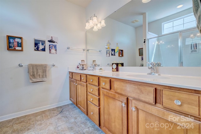 bathroom with vanity and a shower with shower door