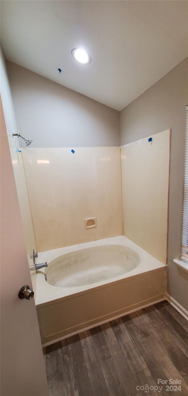 bathroom with shower / bathing tub combination and wood finished floors