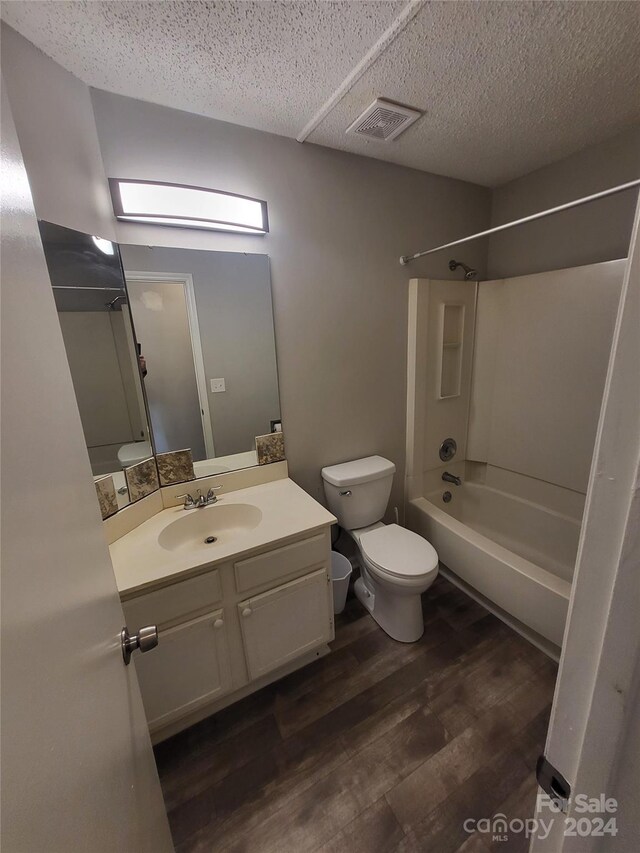 5720 Ebley Ln, Charlotte, NC 28227 - full bathroom with wood finished floors, vanity, washtub / shower combination, and a textured ceiling