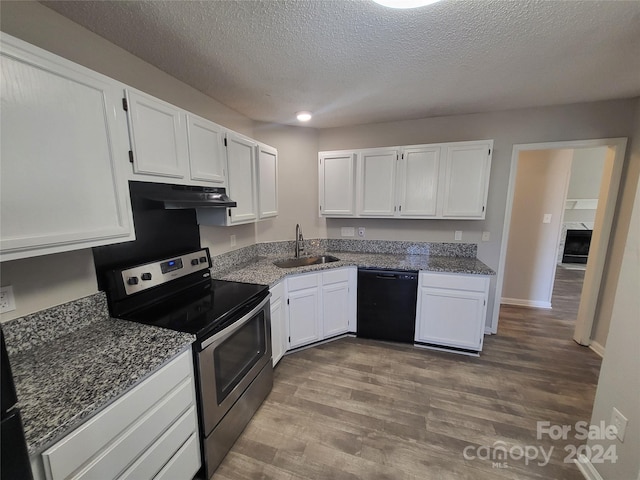 kitchen featuring electric range, a sink, under cabinet range hood, black dishwasher, and white cabinets