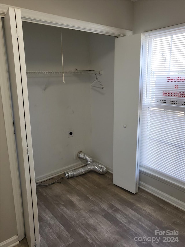 laundry room featuring laundry area, dark wood-style floors, baseboards, and hookup for an electric dryer