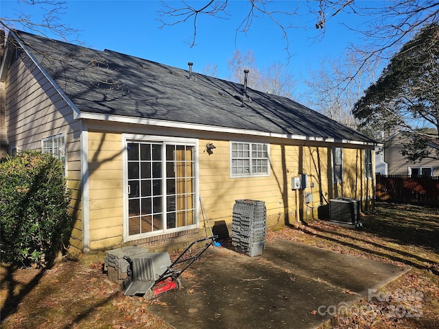 rear view of house featuring cooling unit and a patio area