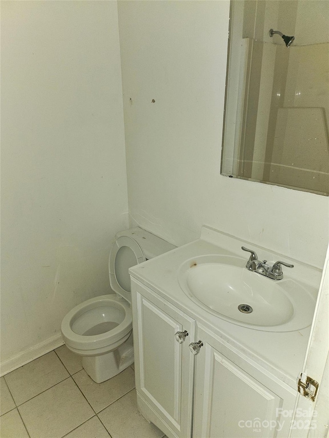 bathroom featuring vanity, tile patterned floors, and toilet