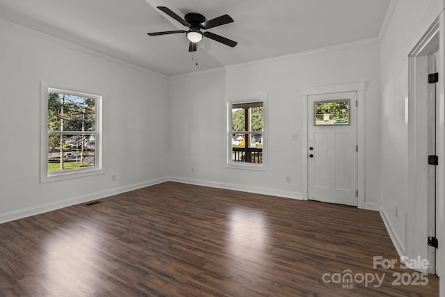 entryway with dark hardwood / wood-style floors, a wealth of natural light, ornamental molding, and ceiling fan