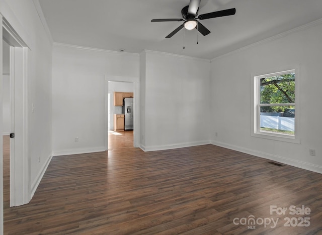 empty room with dark wood-type flooring, ceiling fan, and crown molding