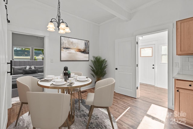 dining area featuring a chandelier, beam ceiling, light hardwood / wood-style flooring, and crown molding