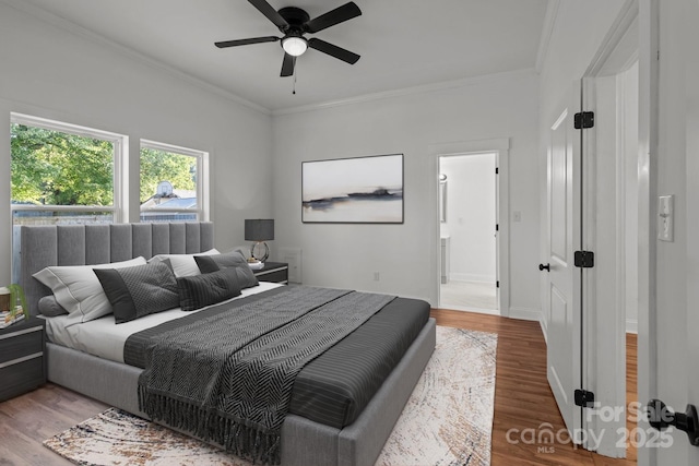 bedroom with ceiling fan, ensuite bathroom, wood-type flooring, and ornamental molding