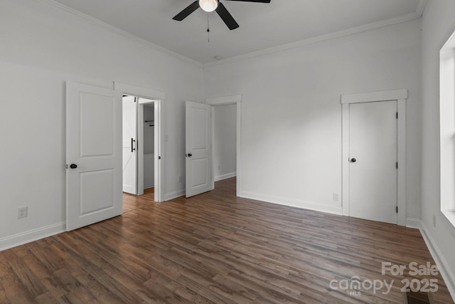 spare room featuring ornamental molding, ceiling fan, and dark wood-type flooring