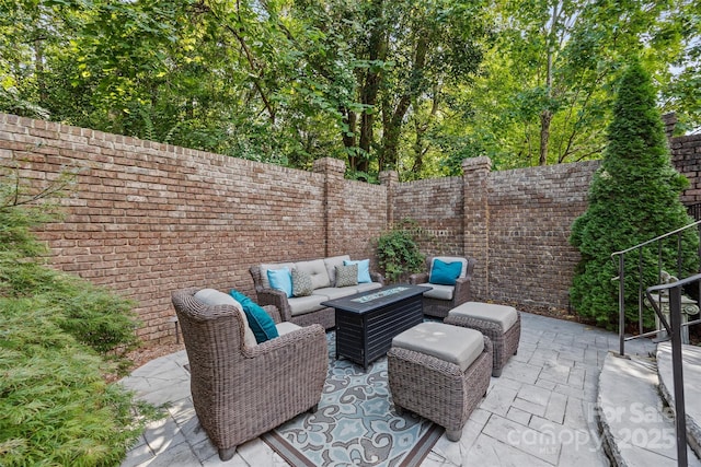 view of patio featuring an outdoor living space with a fire pit