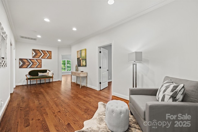 living area featuring crown molding and hardwood / wood-style floors