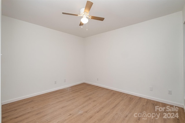 spare room featuring ceiling fan and light wood-type flooring