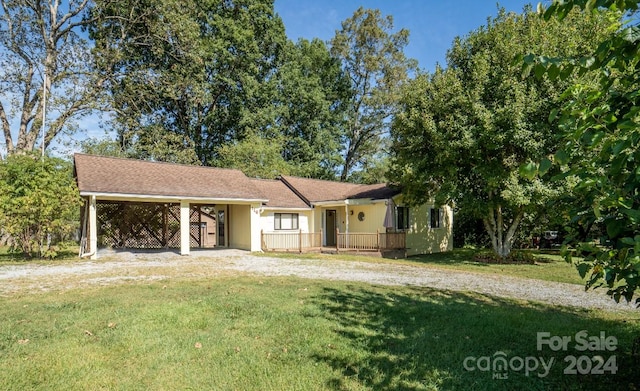 ranch-style home with a front yard and a carport