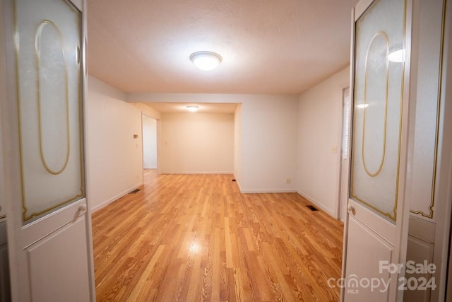 empty room with light hardwood / wood-style flooring