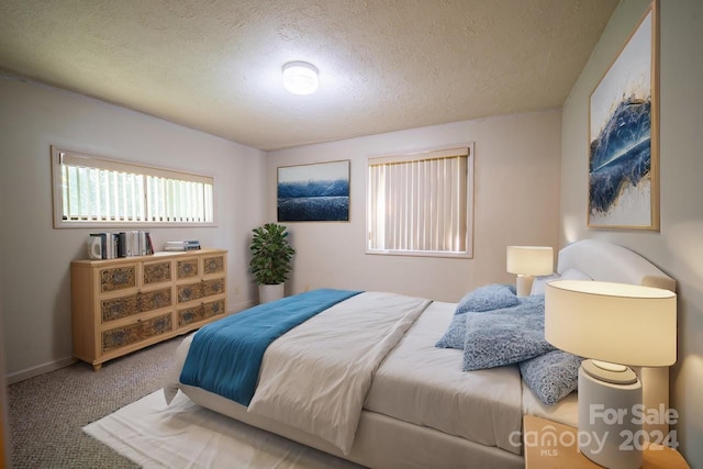 carpeted bedroom featuring a textured ceiling