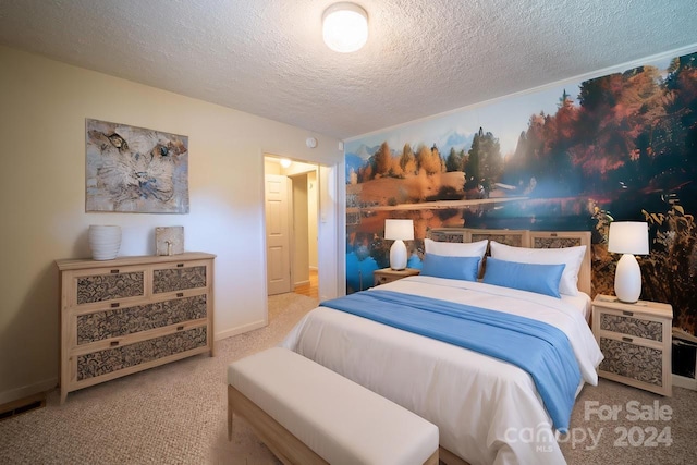 bedroom with a textured ceiling and carpet