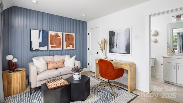 living room featuring baseboards, recessed lighting, and light wood-style floors