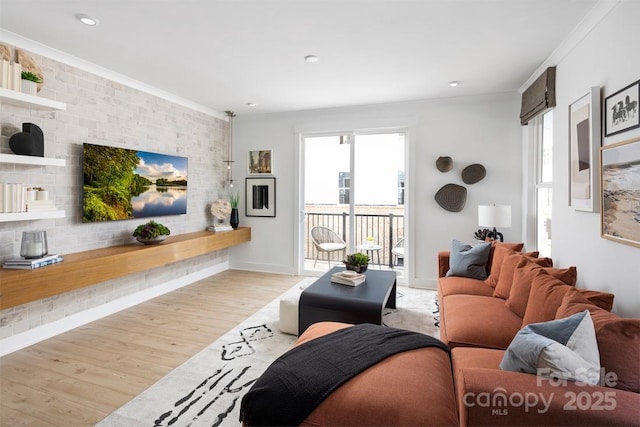 living room featuring ornamental molding, baseboards, light wood-style floors, and recessed lighting