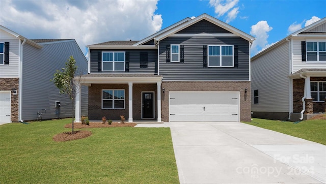 view of front of home featuring a front yard and a garage