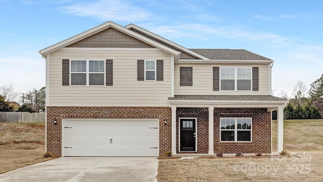 view of front of house with a garage, concrete driveway, roof with shingles, fence, and brick siding