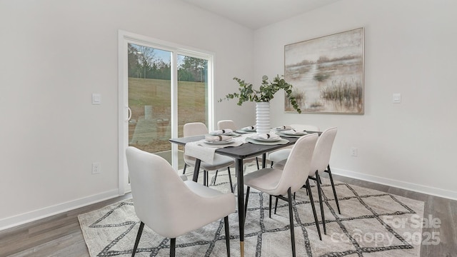 dining room with baseboards and wood finished floors