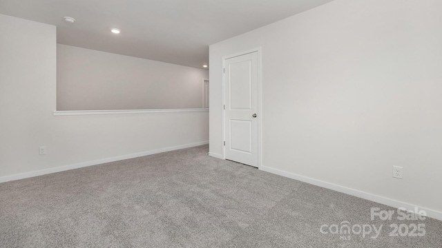 spare room with carpet floors, recessed lighting, and baseboards