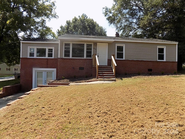 view of front facade featuring a front lawn and french doors