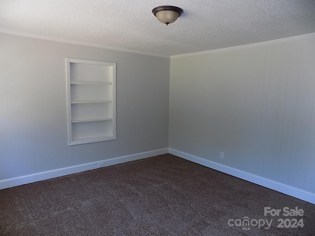 unfurnished room featuring built in features, carpet, crown molding, and a textured ceiling