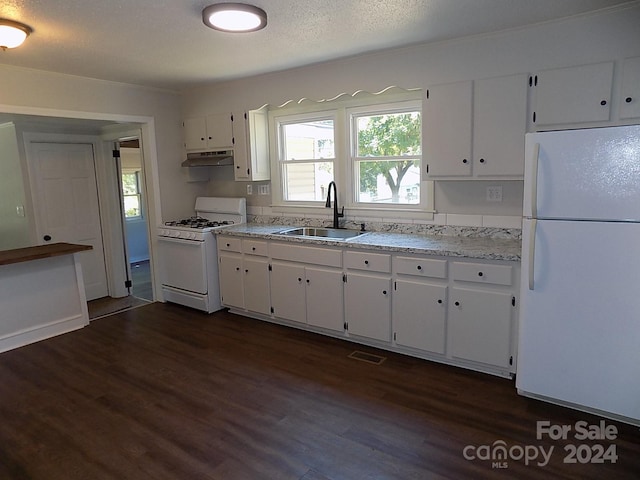 kitchen featuring sink, dark hardwood / wood-style floors, white appliances, and white cabinetry