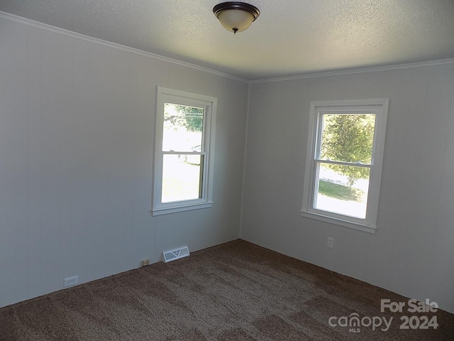 unfurnished room with carpet flooring, plenty of natural light, and ornamental molding