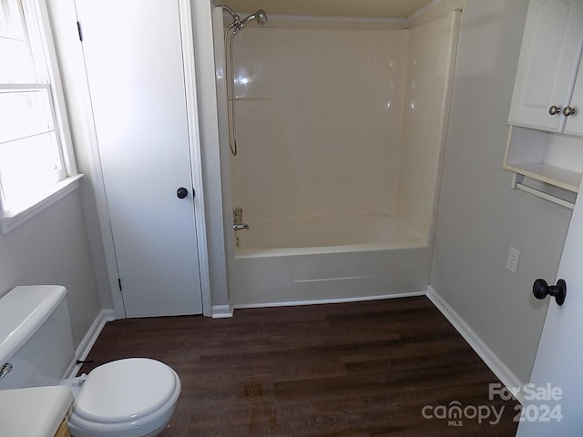 bathroom featuring toilet,  shower combination, and wood-type flooring