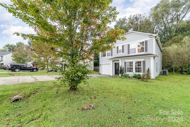 exterior space with central AC unit, a garage, and a front lawn