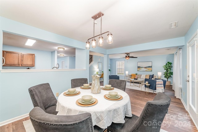 dining room featuring wood-type flooring and ceiling fan