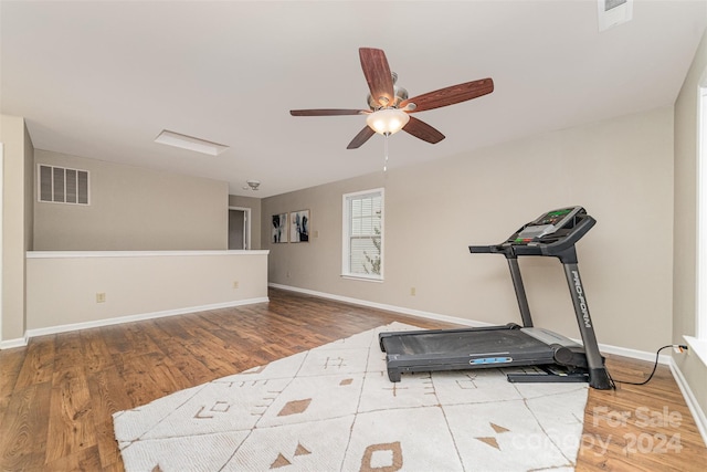 workout area featuring ceiling fan and hardwood / wood-style flooring