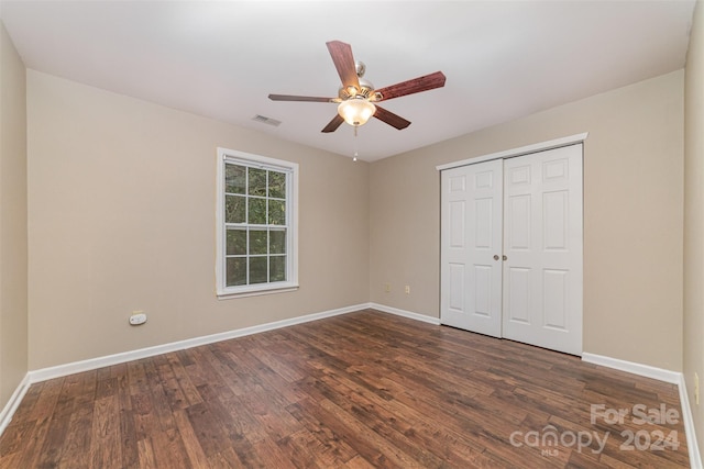 unfurnished bedroom featuring ceiling fan, a closet, and dark hardwood / wood-style floors