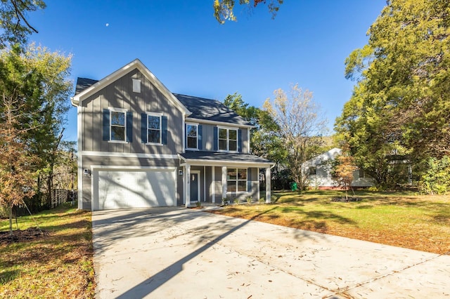 view of front of property featuring a front yard and a garage