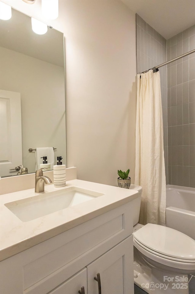 full bathroom with shower / bath combo with shower curtain, vanity, and toilet