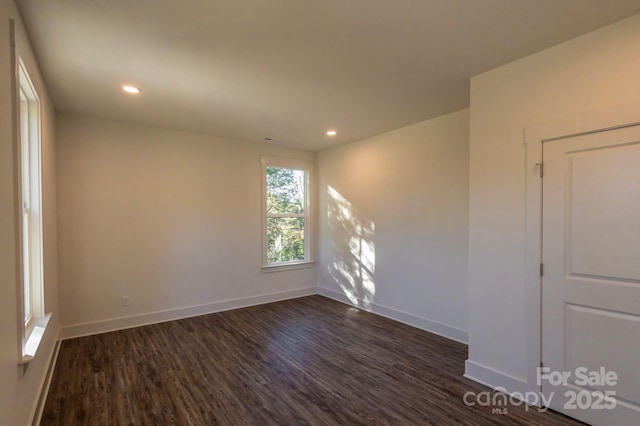 spare room with dark hardwood / wood-style floors