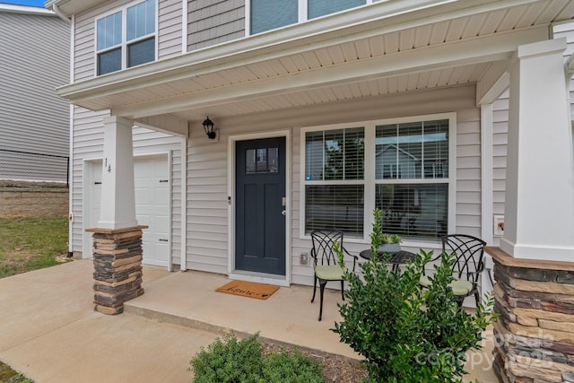 entrance to property with a porch and a garage