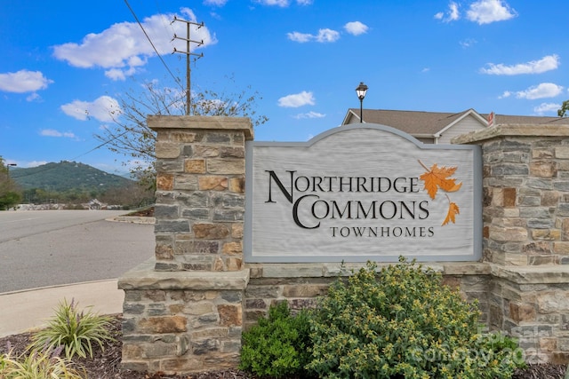 community sign with a mountain view