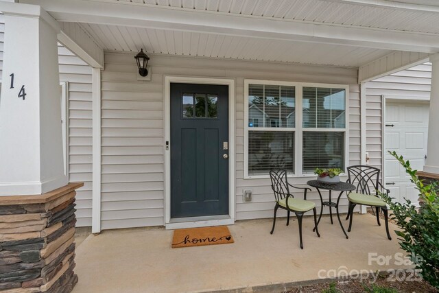 doorway to property with covered porch