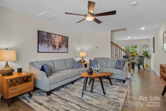 living room with hardwood / wood-style flooring and ceiling fan