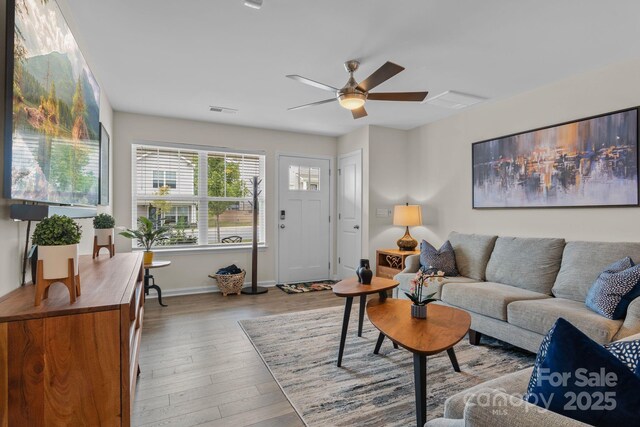 living room with ceiling fan and light wood-type flooring