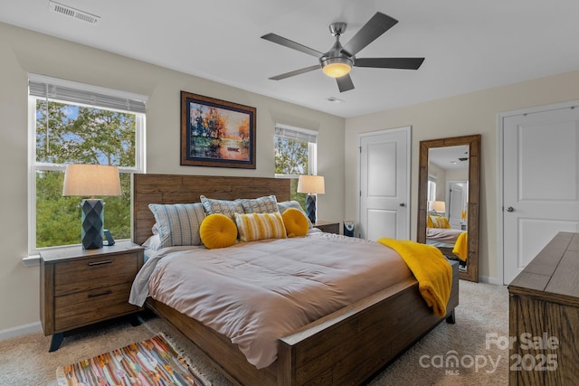 bedroom with ceiling fan and light carpet