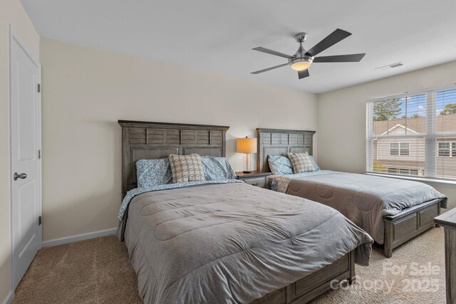 bedroom with ceiling fan and light carpet