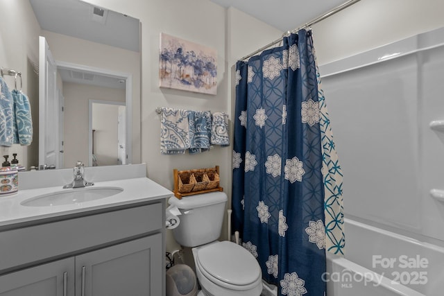 full bathroom with shower / tub combo, vanity, and toilet